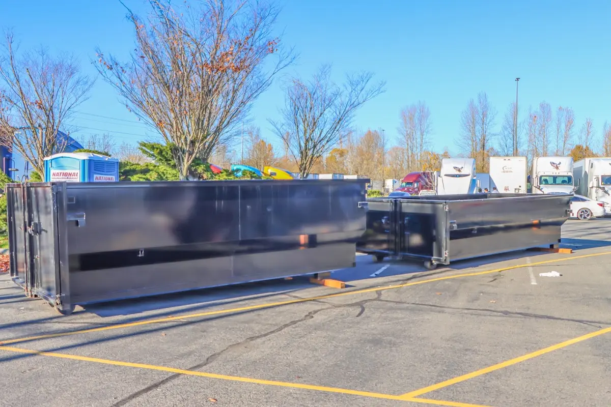 Professional dumpster rental service with roll-off container on residential driveway in Town and Country